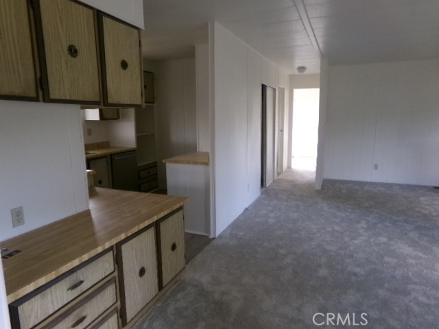 323 Ridgecrest Parkway Oroville, CA 95966 - Photo 13 of 35 a kitchen with stainless steel appliances granite countertop a refrigerator and a stove top oven