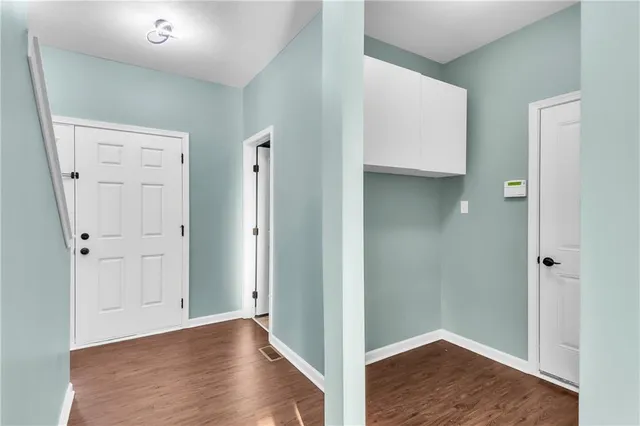 an empty room with wooden floor