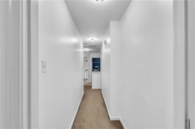 a view of a hallway with a white walls