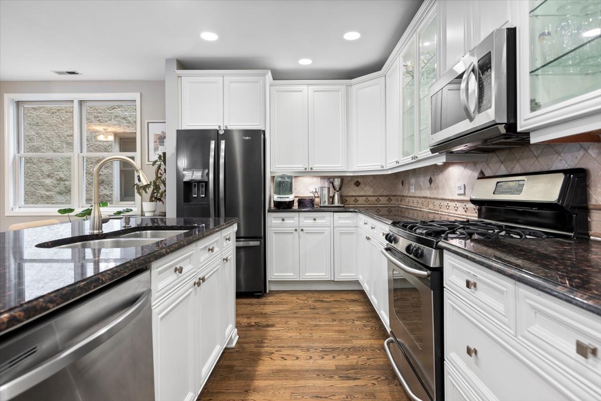 1132 West Wolfram Street, Unit 3 Chicago, IL 60657 - Photo 11 of 26 a kitchen with granite countertop a refrigerator stove top oven and sink
