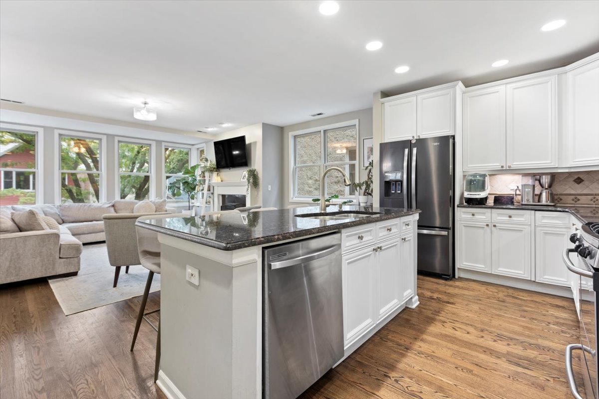 1132 West Wolfram Street, Unit 3 Chicago, IL 60657 - Photo 12 of 26 a kitchen with stainless steel appliances kitchen island granite countertop a stove refrigerator and cabinets