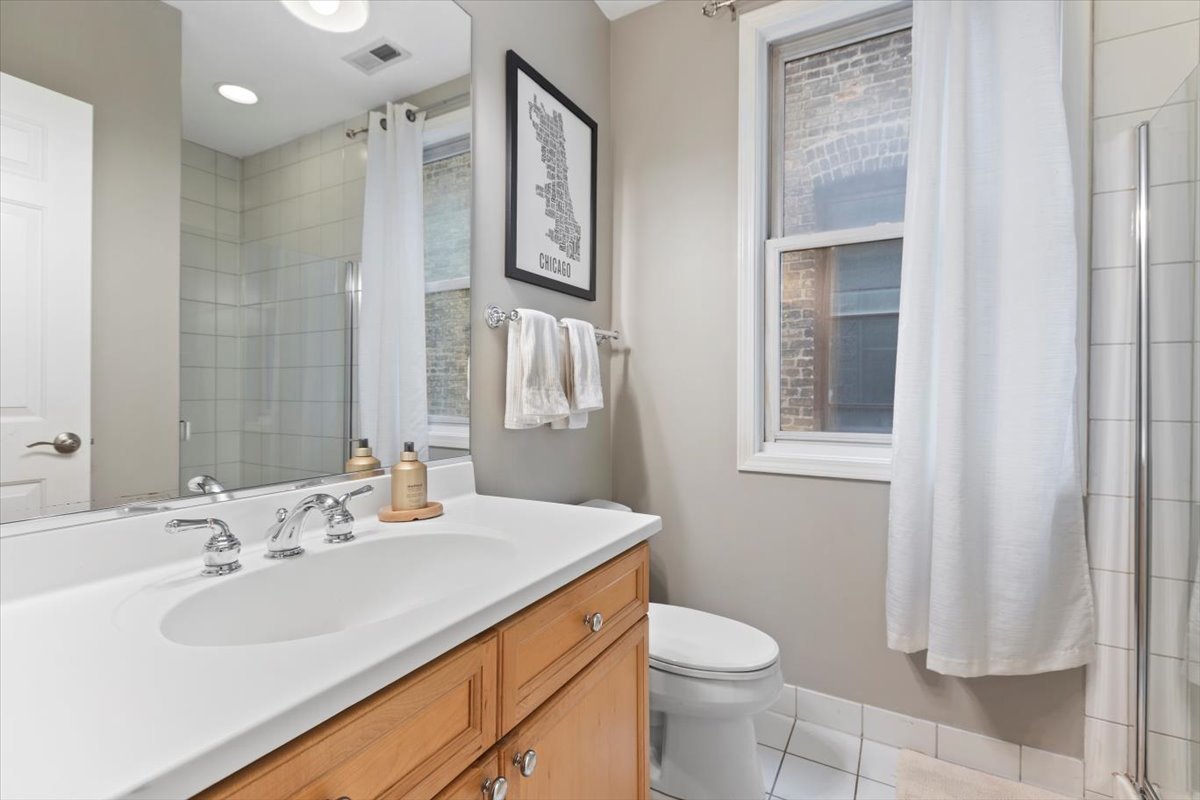 1132 West Wolfram Street, Unit 3 Chicago, IL 60657 - Photo 13 of 26 a bathroom with a sink toilet and shower