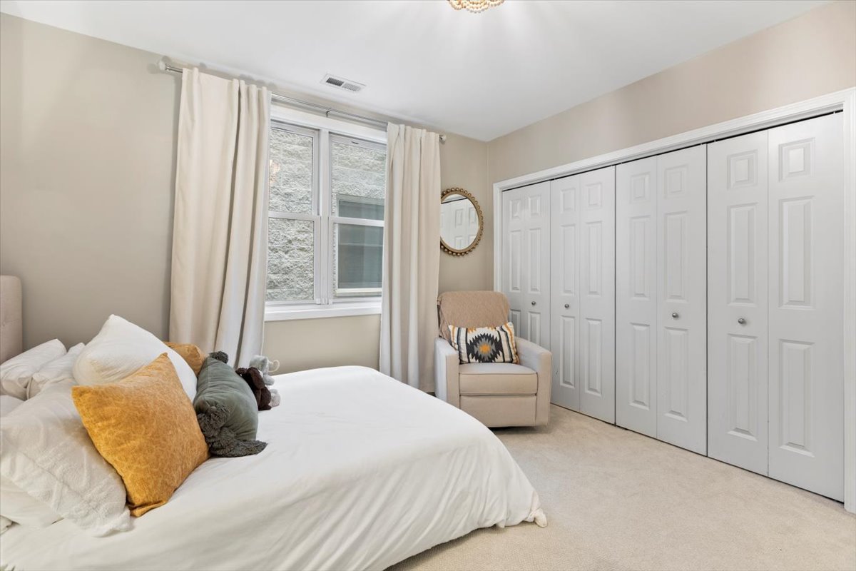 1132 West Wolfram Street, Unit 3 Chicago, IL 60657 - Photo 17 of 26 a bedroom with a large bed and a window