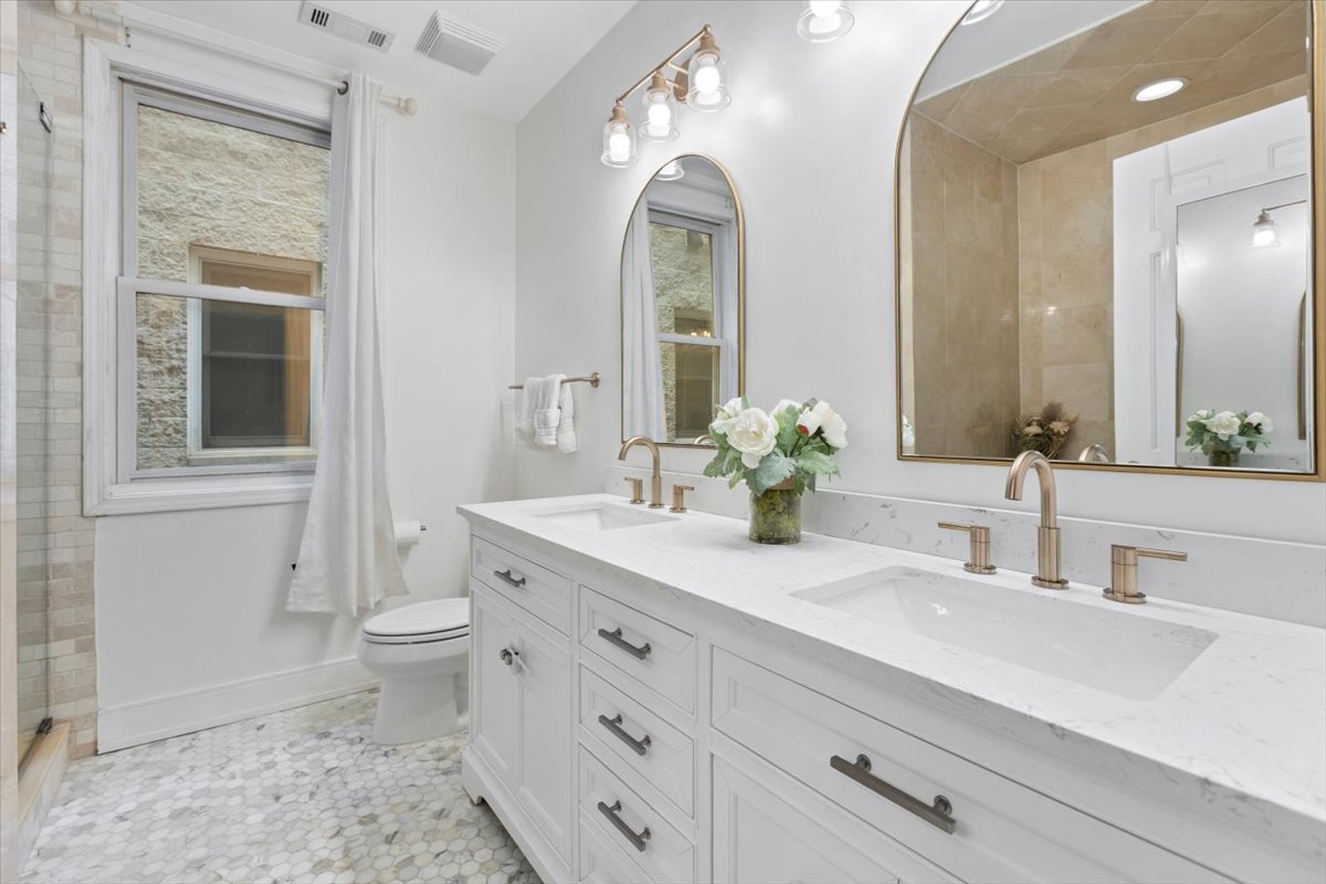 1132 West Wolfram Street, Unit 3 Chicago, IL 60657 - Photo 18 of 26 a bathroom with a granite countertop sink mirror and toilet