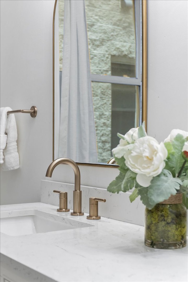 1132 West Wolfram Street, Unit 3 Chicago, IL 60657 - Photo 19 of 26 a bathroom with a sink a mirror and a window