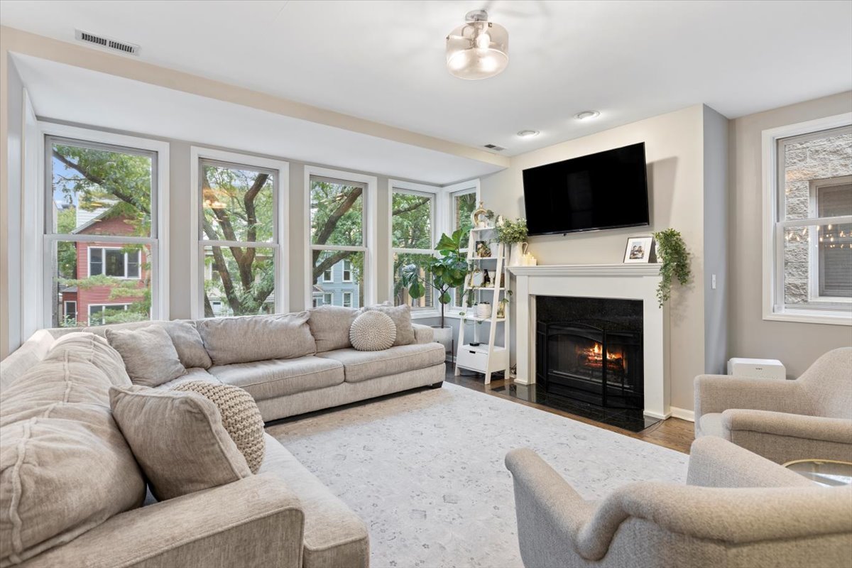 1132 West Wolfram Street, Unit 3 Chicago, IL 60657 - Photo 2 of 26 a living room with furniture fireplace and flat screen tv