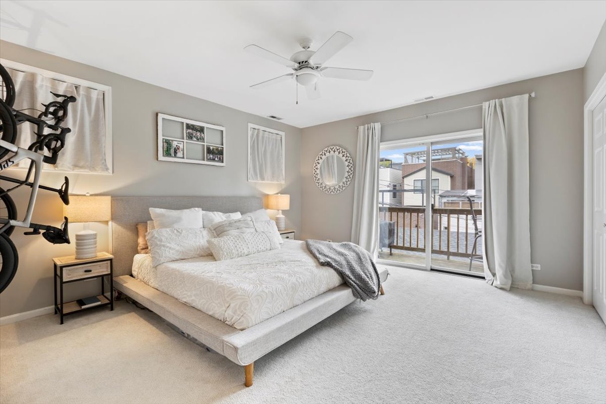 1132 West Wolfram Street, Unit 3 Chicago, IL 60657 - Photo 22 of 26 a bed room with a bed and a chandelier
