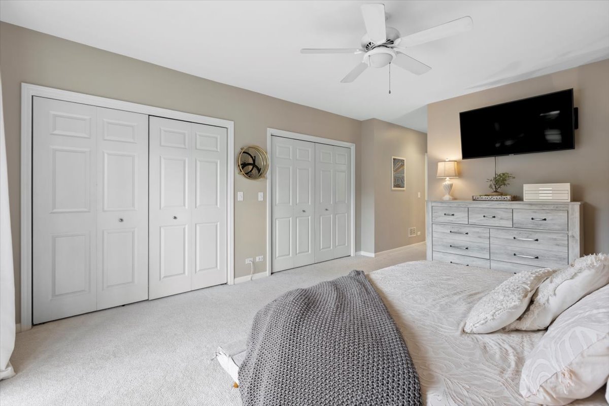 1132 West Wolfram Street, Unit 3 Chicago, IL 60657 - Photo 24 of 26 a spacious bedroom with a bed and a flat screen tv