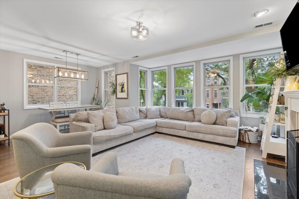 1132 West Wolfram Street, Unit 3 Chicago, IL 60657 - Photo 4 of 26 a living room with furniture and a large window