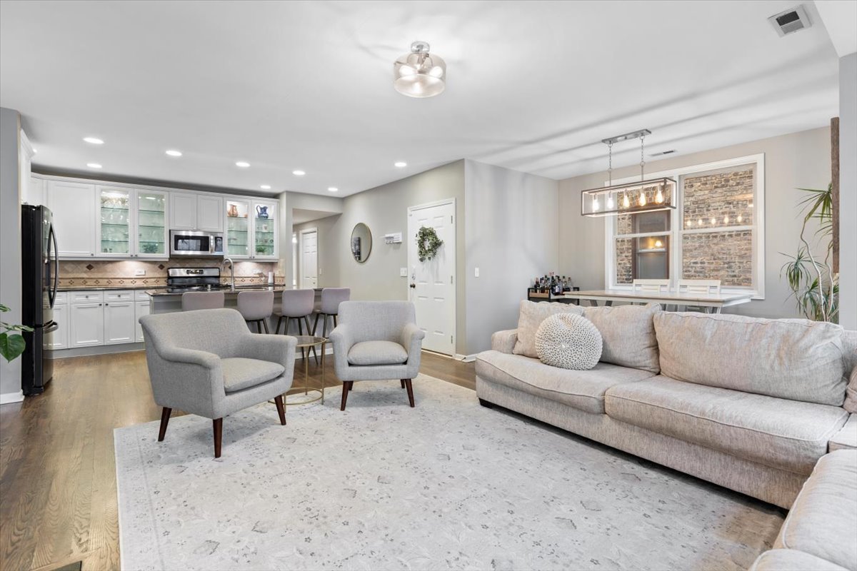 1132 West Wolfram Street, Unit 3 Chicago, IL 60657 - Photo 5 of 26 a living room with furniture and a large window
