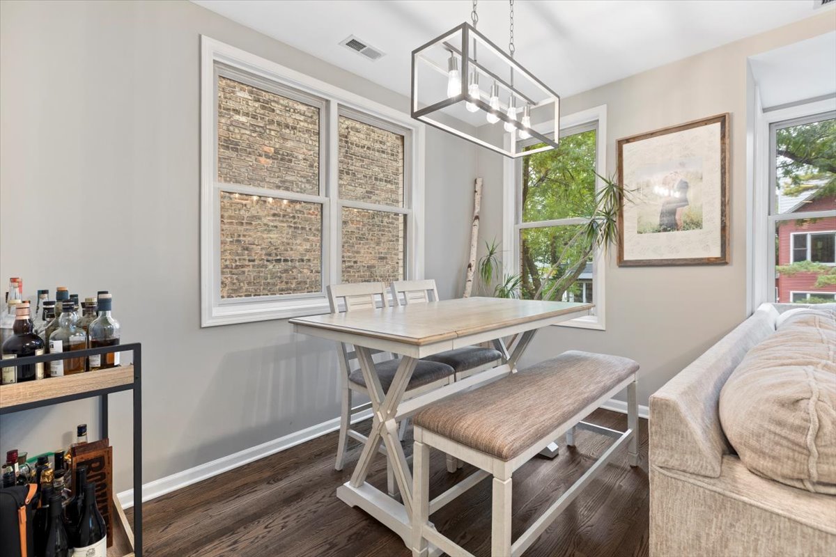 1132 West Wolfram Street, Unit 3 Chicago, IL 60657 - Photo 6 of 26 a room with wooden floor and windows