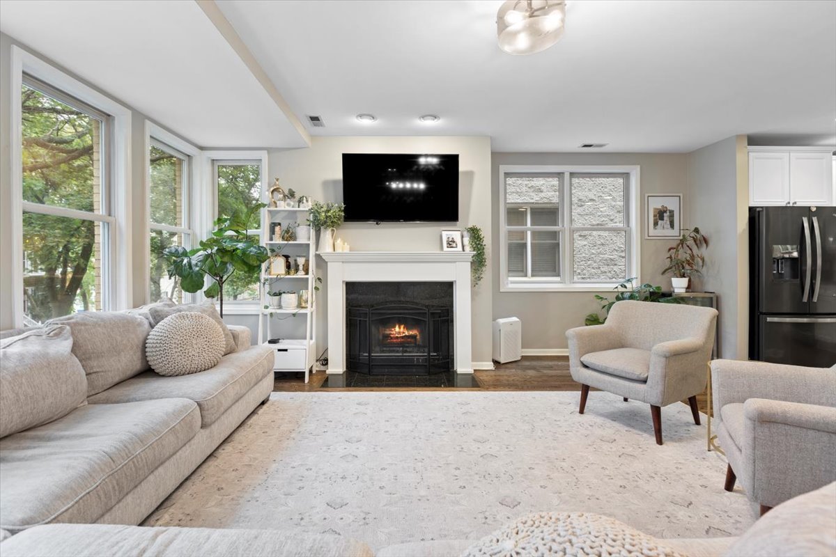 1132 West Wolfram Street, Unit 3 Chicago, IL 60657 - Photo 7 of 26 a living room with furniture a fireplace and a flat screen tv