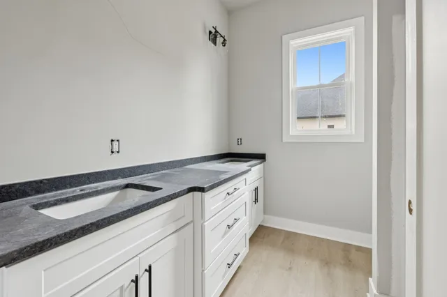 a view of a kitchen with white cabinets
