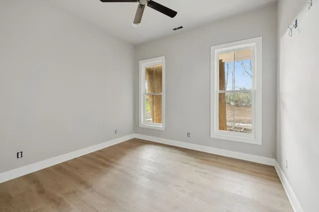 an empty room with windows and closet
