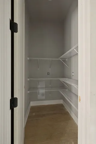 a view of walk in closet with empty racks