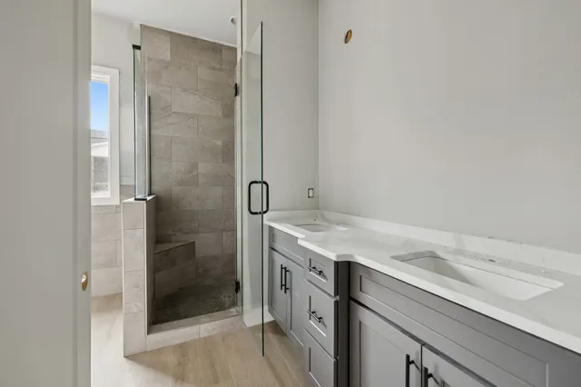 a bathroom with a granite countertop sink a shower and a mirror