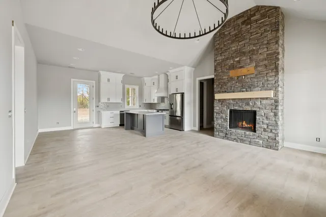 a view of empty room with a fireplace