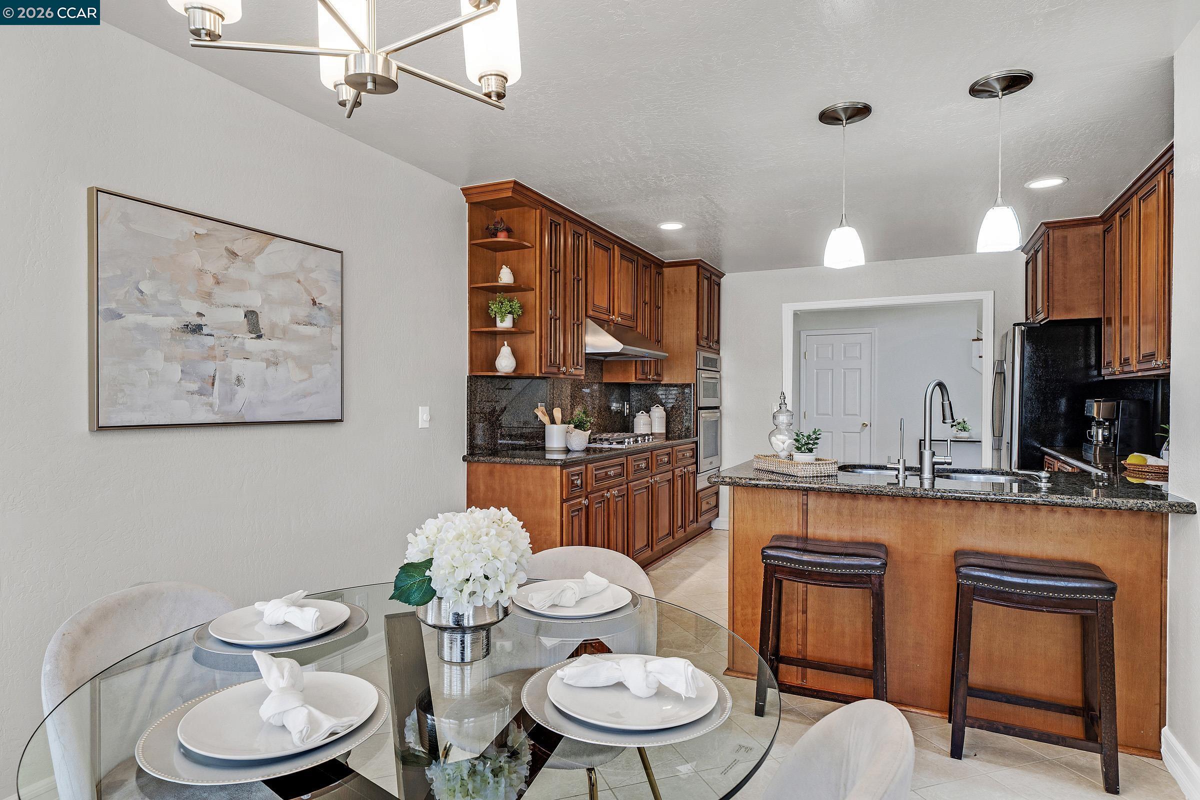 2415 Crestline Road Pleasanton, CA 94566 - Photo 11 of 40 a kitchen with stainless steel appliances a dining table and chair