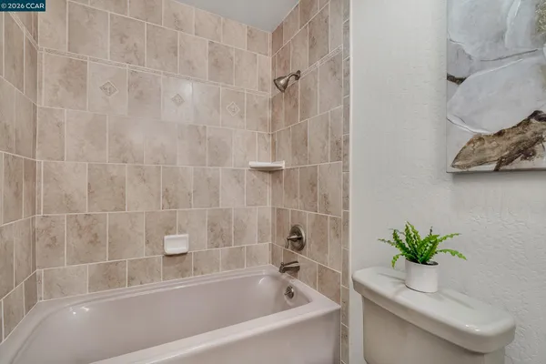 a white bath tub with a shower
