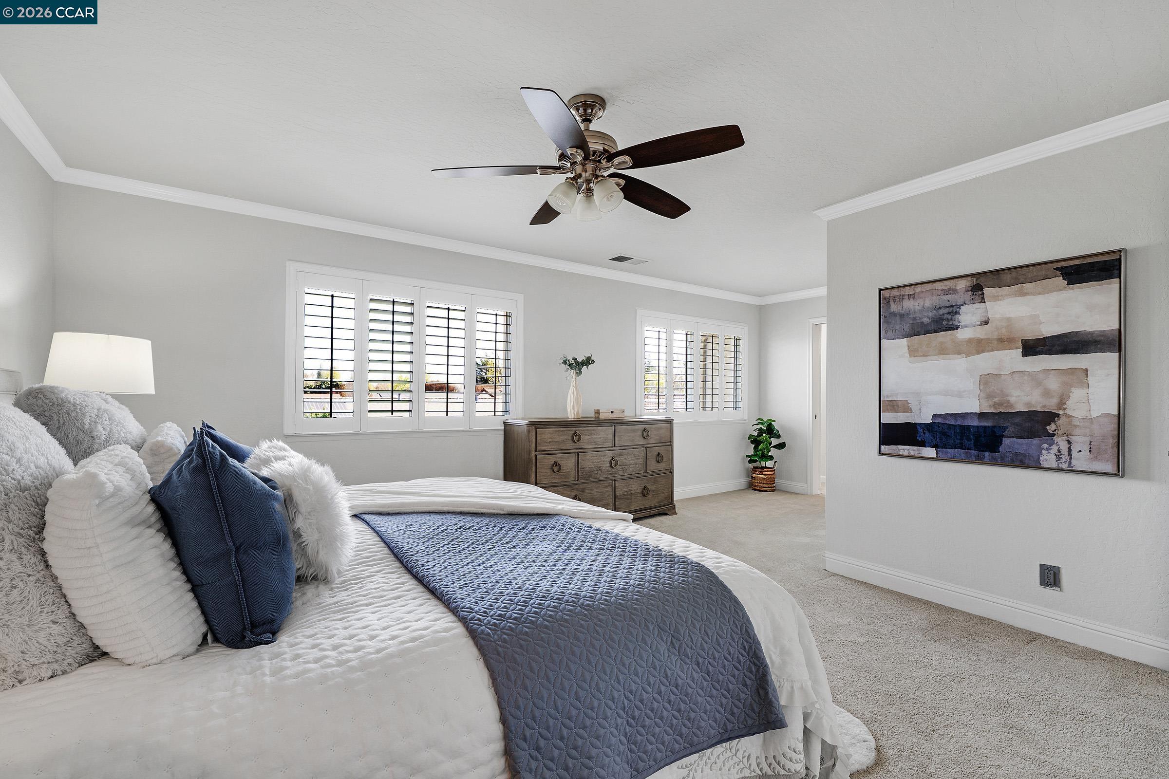 2415 Crestline Road Pleasanton, CA 94566 - Photo 26 of 40 a spacious bedroom with a bed a window and a couch