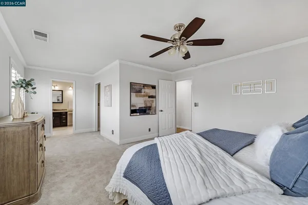 a bedroom with a large bed and dresser