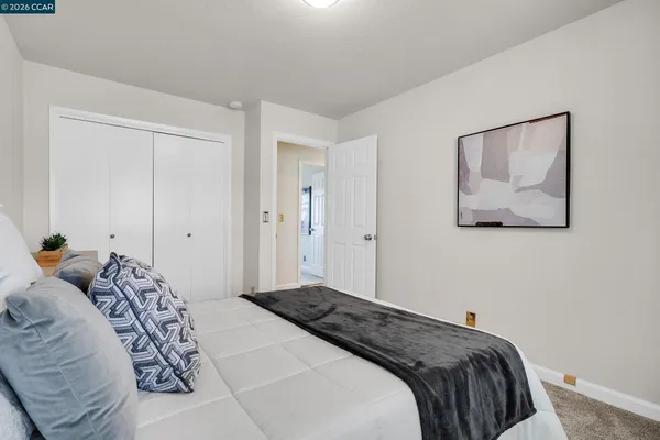 a bedroom with a bed and hallway