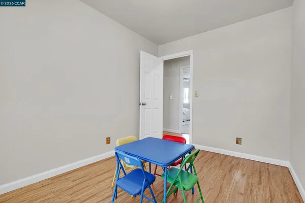 a view of a room with furniture and wooden floor