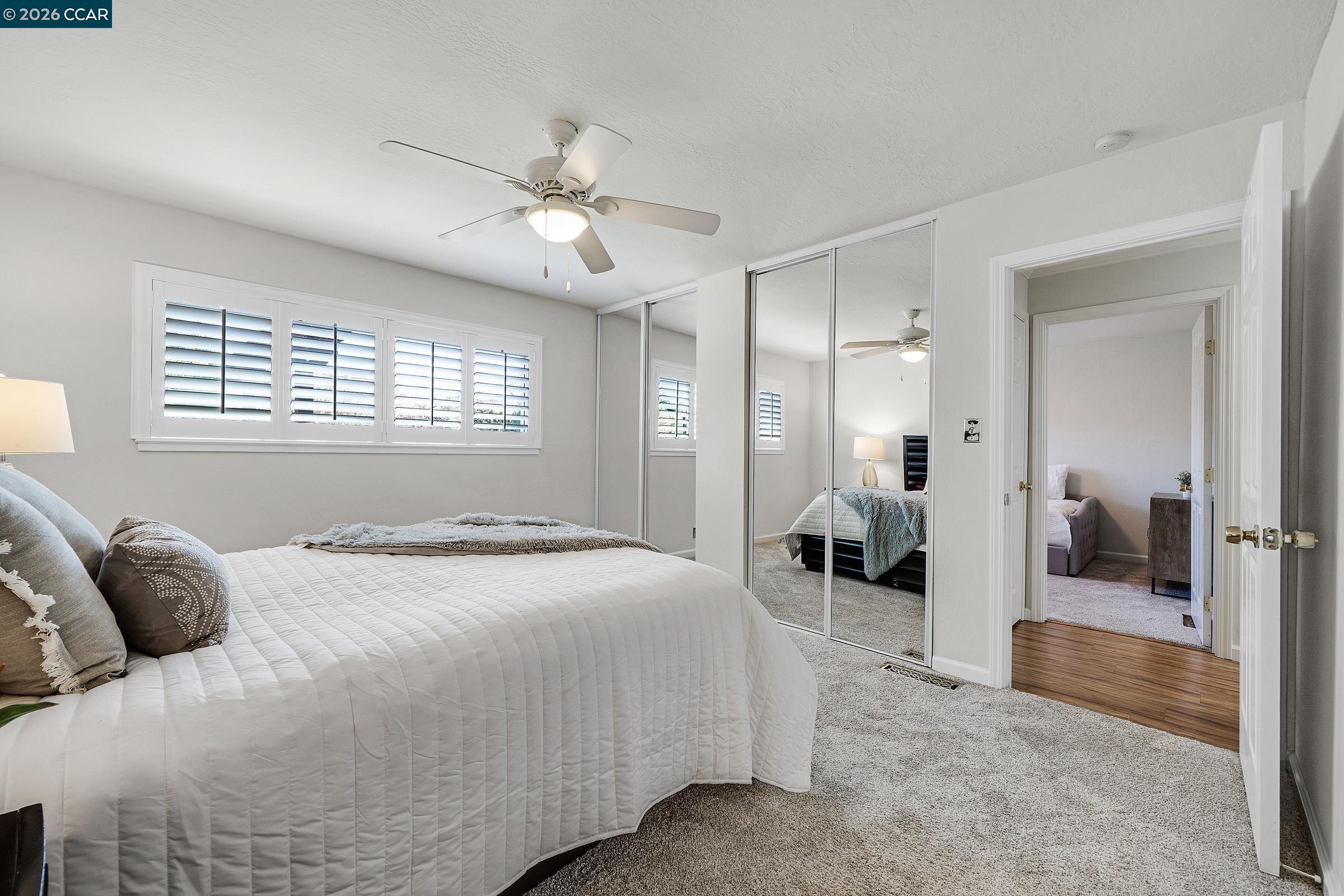 2415 Crestline Road Pleasanton, CA 94566 - Photo 33 of 40 a bedroom with a large bed and a chandelier