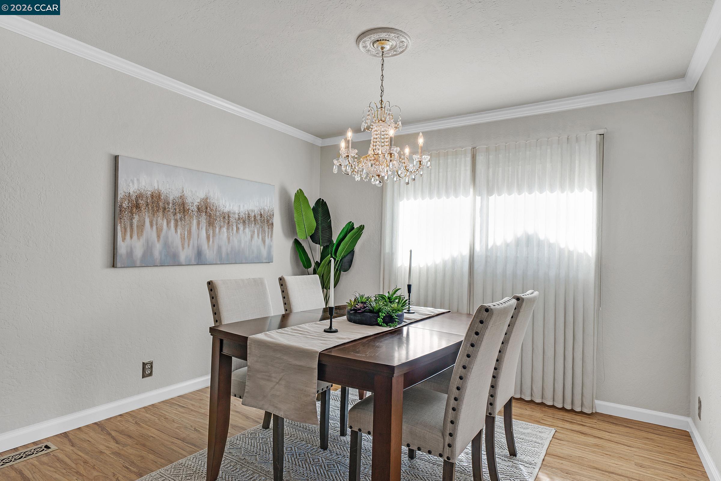 2415 Crestline Road Pleasanton, CA 94566 - Photo 6 of 40 a dining room with furniture a chandelier and wooden floor