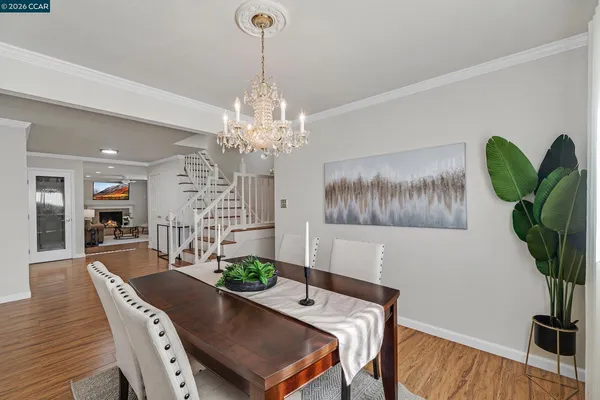 a view of a dining room with furniture wooden floor and chandelier