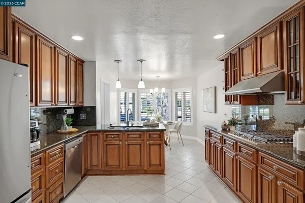 a kitchen with stainless steel appliances a sink stove and cabinets