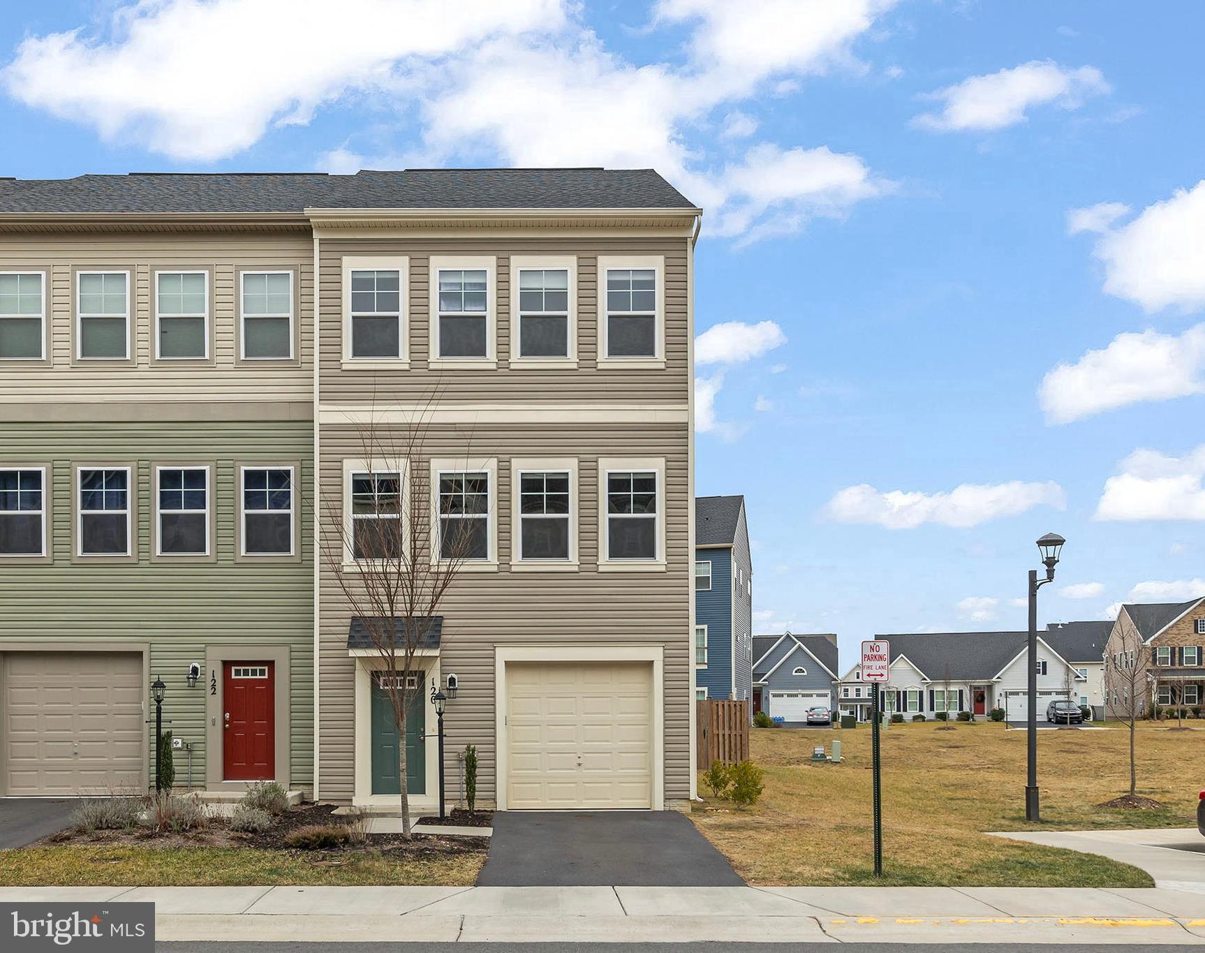 a front view of a building with a garden