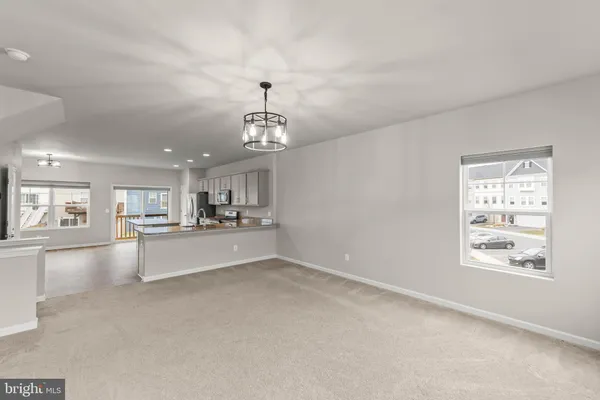 a view of a kitchen with windows and cabinet