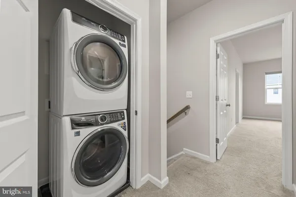 a view of a hallway with washer and dryer