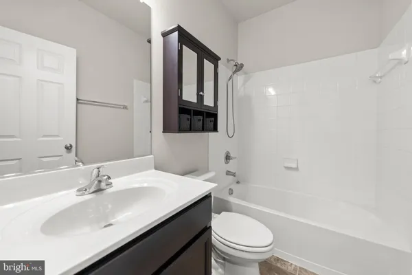 a bathroom with a sink toilet vanity and shower