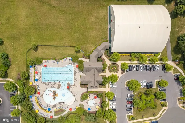 an aerial view of residential houses with outdoor seating and garden