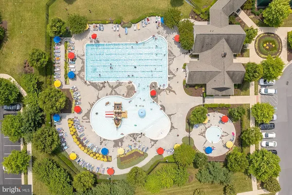 an aerial view of a house with a yard and lake view