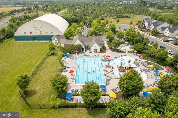 an aerial view of residential houses with outdoor space and swimming pool