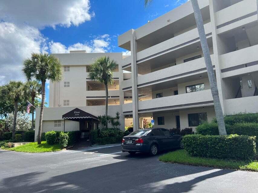 3154 Via Poinciana, Unit 214 Lake Worth, FL 33467 - Photo 21 of 23 a view of a building with a garden and pathway