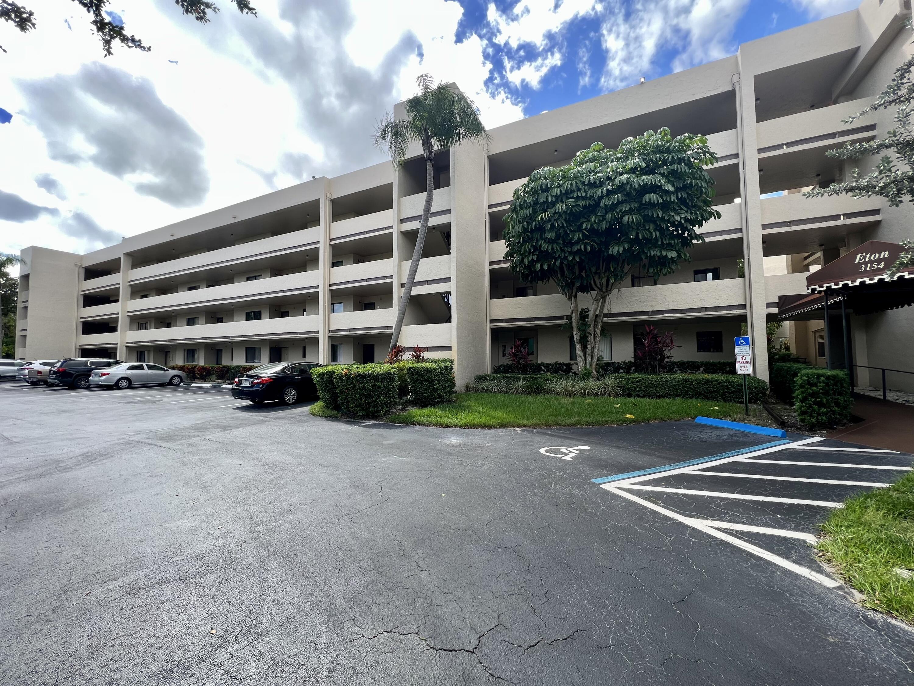 3154 Via Poinciana, Unit 214 Lake Worth, FL 33467 - Photo 23 of 23 a view of a building with a yard