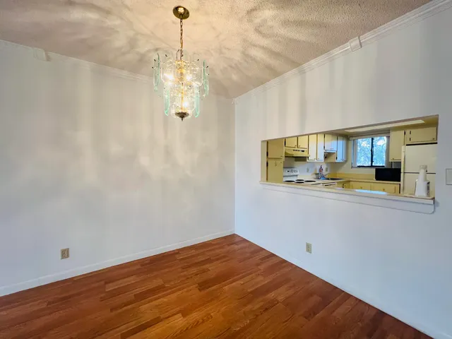 a view of kitchen and hallway with wooden floor