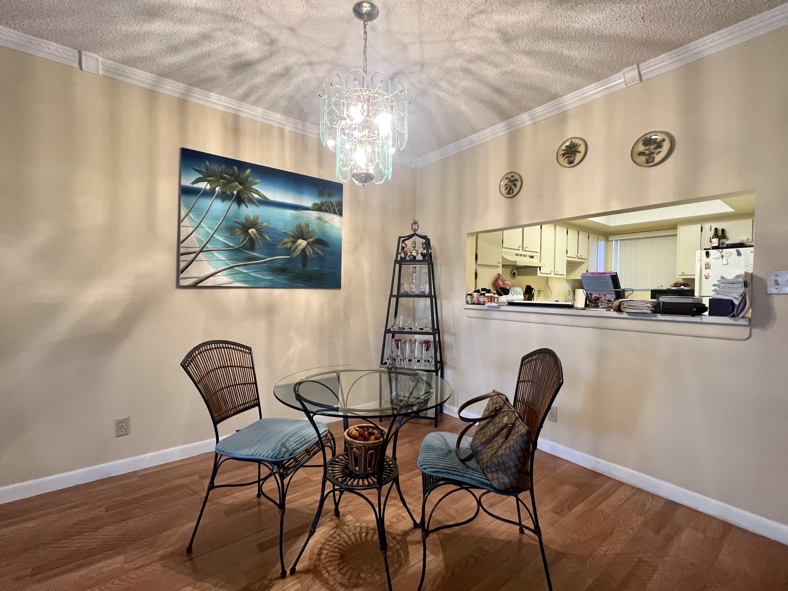 3154 Via Poinciana, Unit 214 Lake Worth, FL 33467 - Photo 6 of 23 a dining room with furniture and window