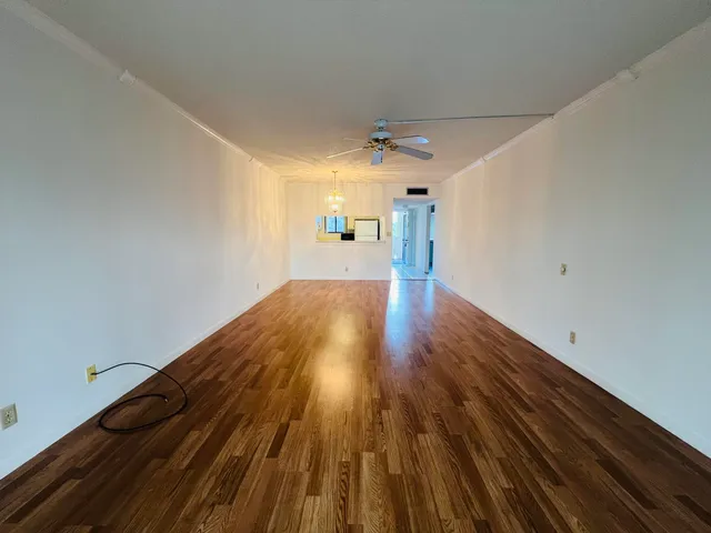 a view of a room with wooden floor