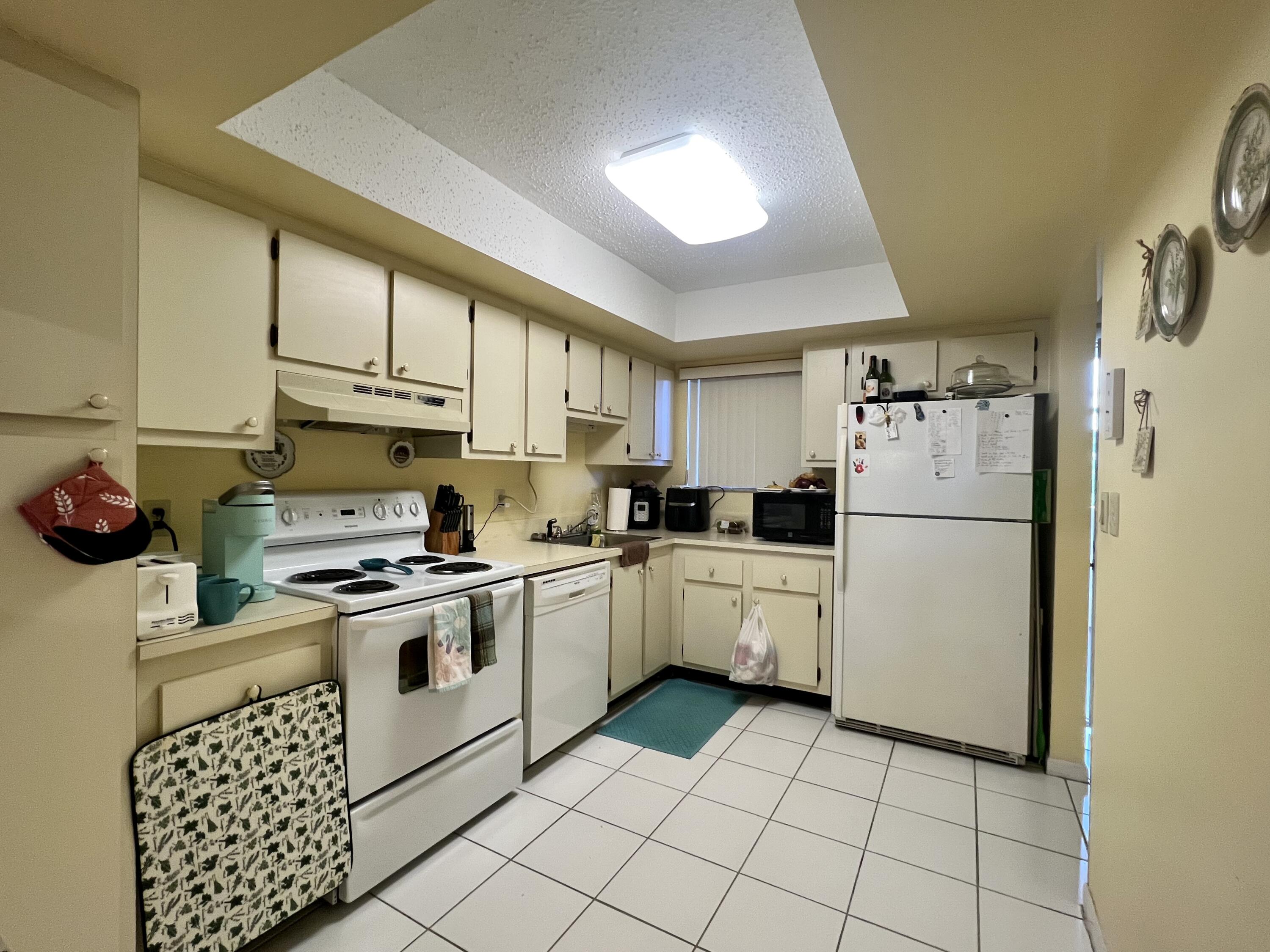 3154 Via Poinciana, Unit 214 Lake Worth, FL 33467 - Photo 10 of 23 a kitchen with appliances cabinets and a sink