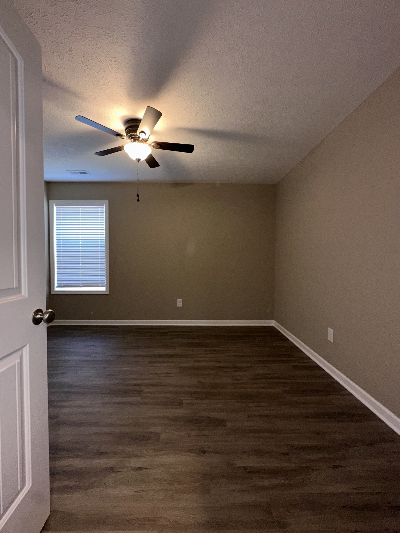 517 Weaver Street, Unit 4 Tullahoma, TN 37388 - Photo 13 of 22 a view of a room with wooden floor and a ceiling fan