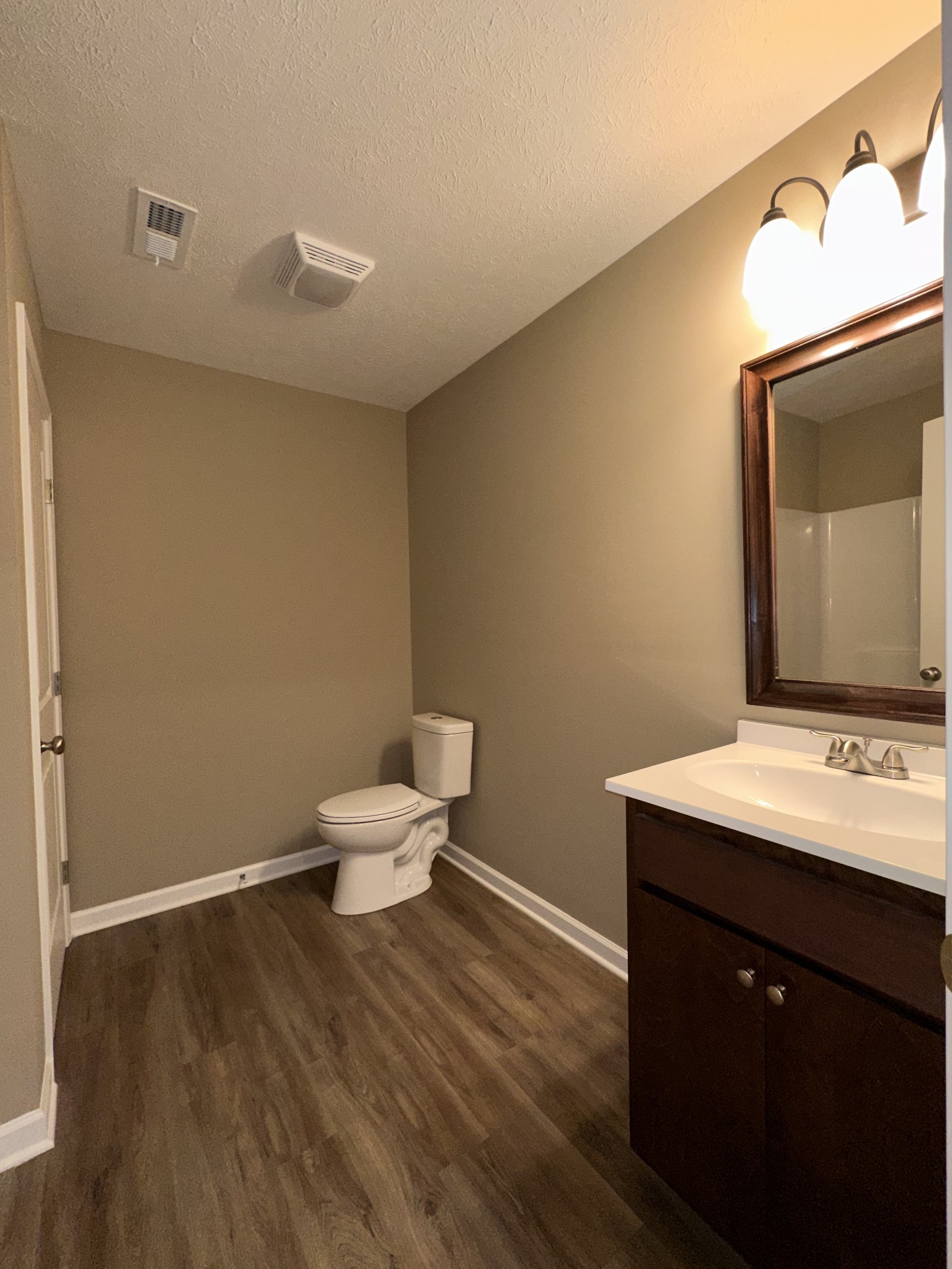 517 Weaver Street, Unit 4 Tullahoma, TN 37388 - Photo 17 of 22 a bathroom with a sink vanity mirror and toilet