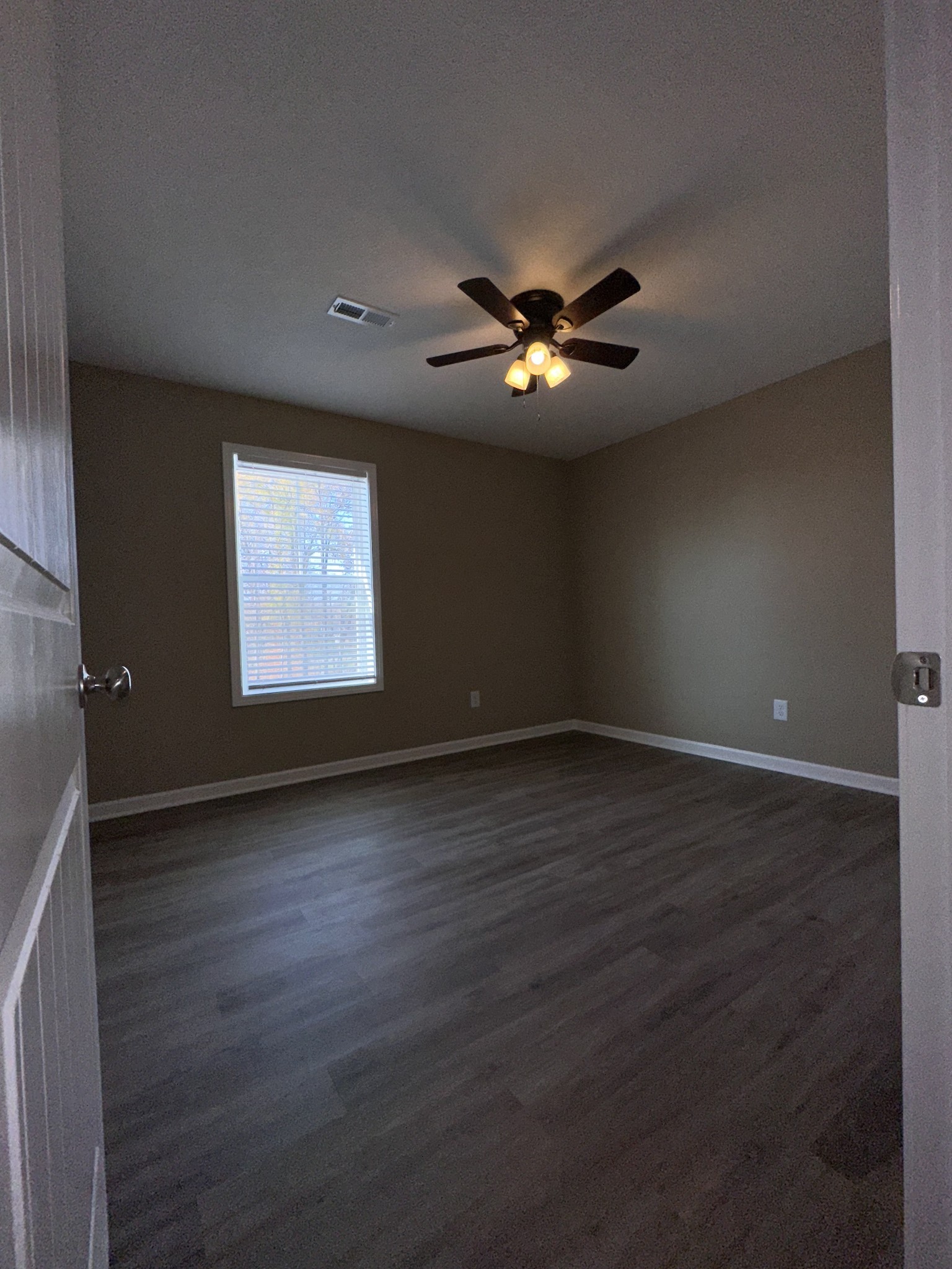 517 Weaver Street, Unit 4 Tullahoma, TN 37388 - Photo 19 of 22 wooden floor in an empty room with a window