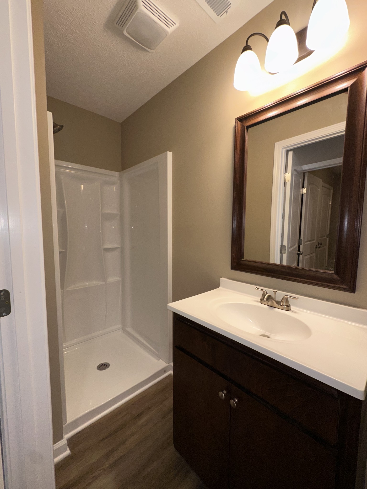 517 Weaver Street, Unit 4 Tullahoma, TN 37388 - Photo 6 of 22 a bathroom with a sink a mirror and a shower