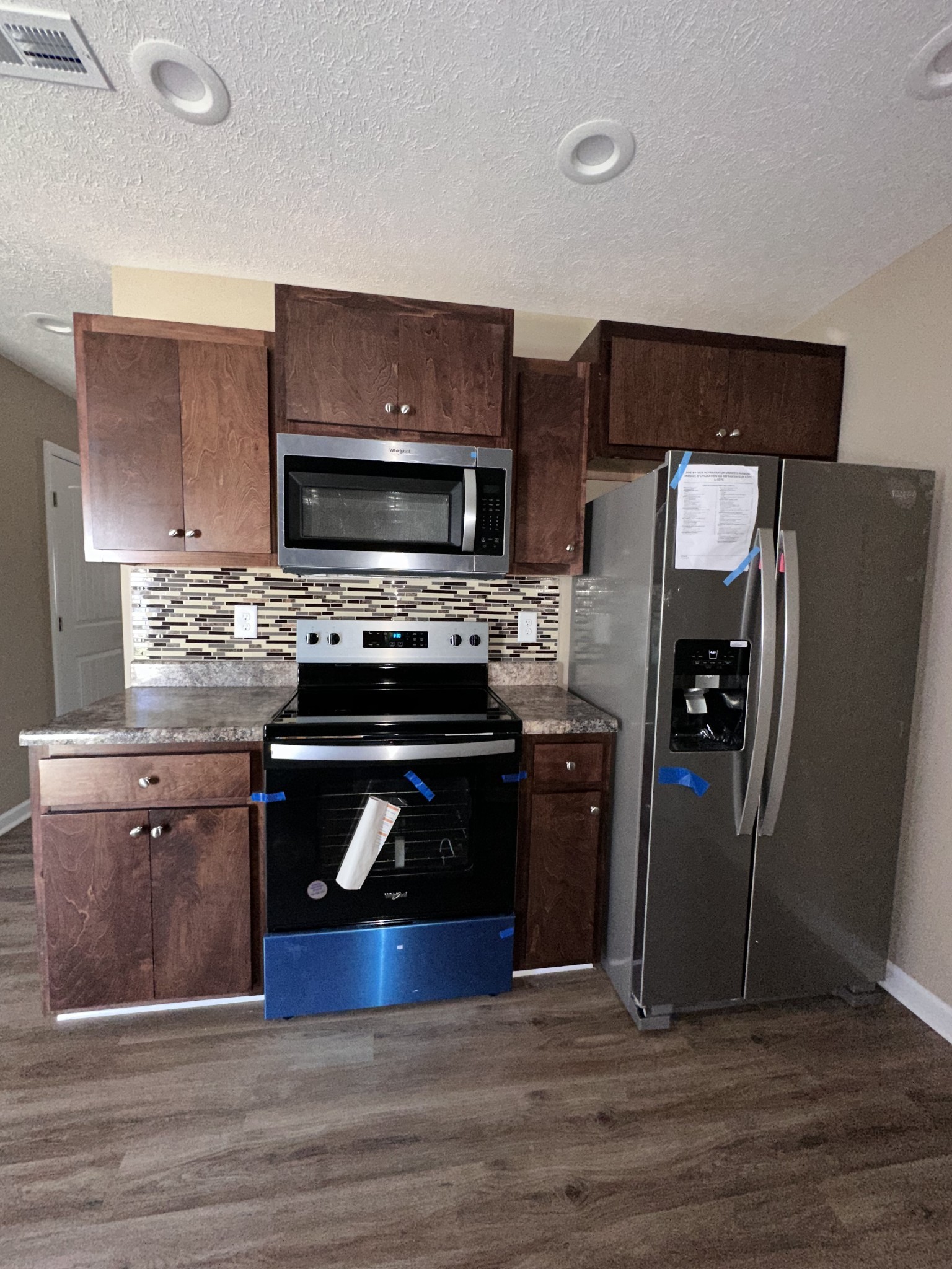 517 Weaver Street, Unit 4 Tullahoma, TN 37388 - Photo 8 of 22 a kitchen with stainless steel appliances wooden cabinets and a stove top oven