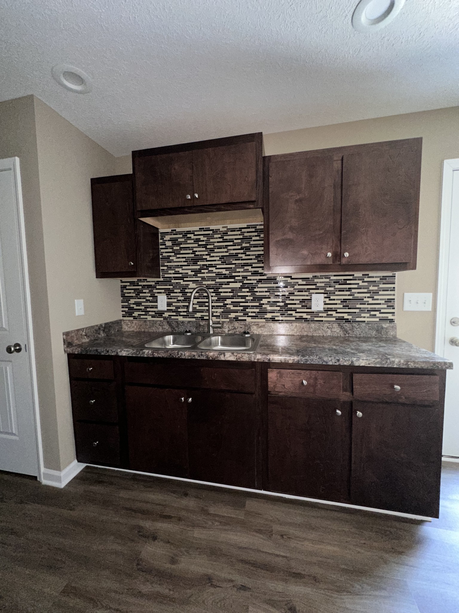 517 Weaver Street, Unit 4 Tullahoma, TN 37388 - Photo 9 of 22 a kitchen with stainless steel appliances granite countertop wooden cabinets and a wooden floor